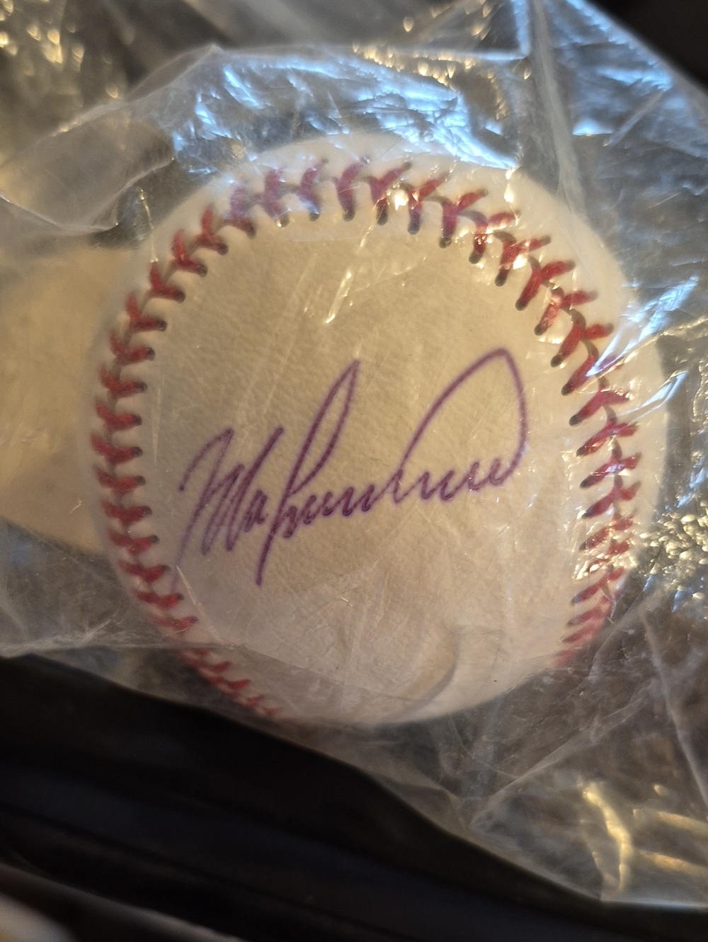 Autographed White Baseball with Purple Ink Signature